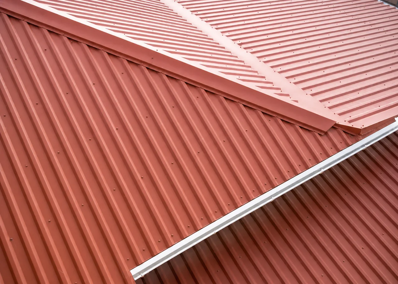 Red R-Panel roofing on a home in Louisiana